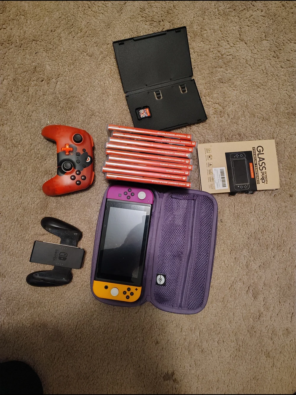 Nintendo handheld with Purple Carry Case and Yellow/Purple Joy‑Con